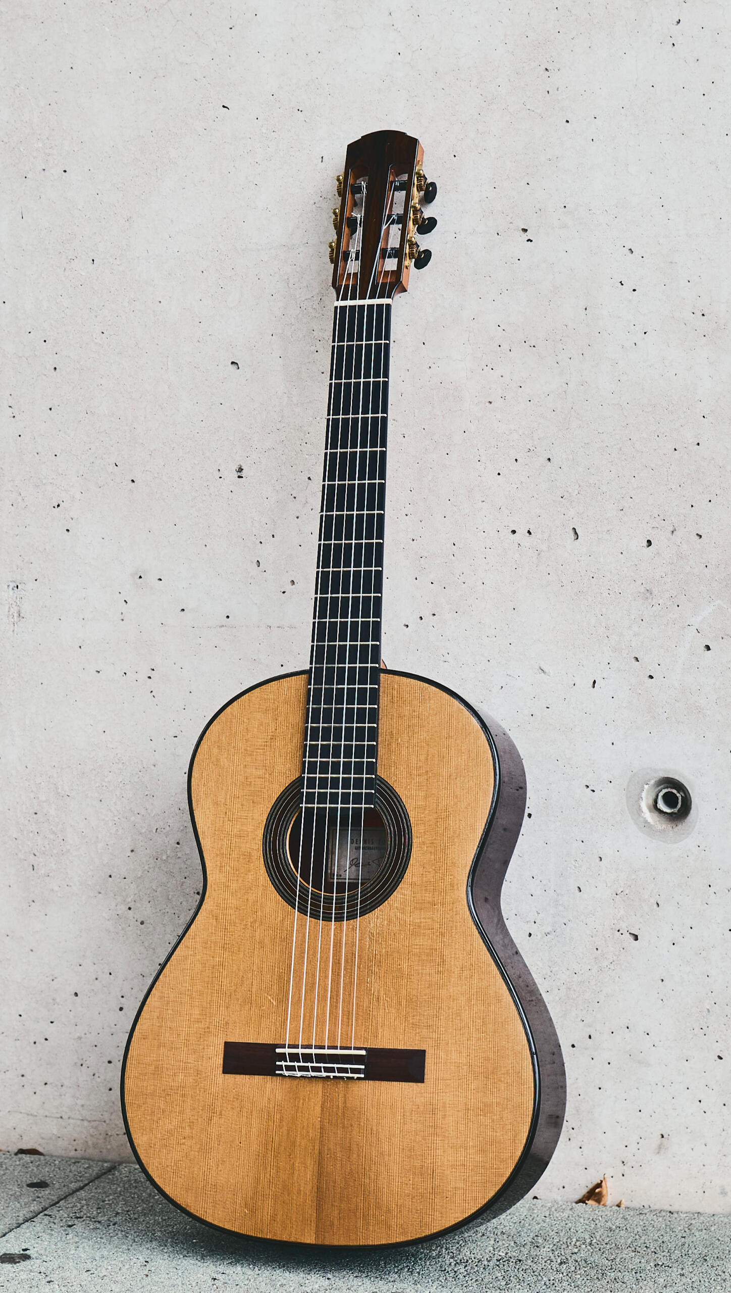 Classical guitar leaning against the wall